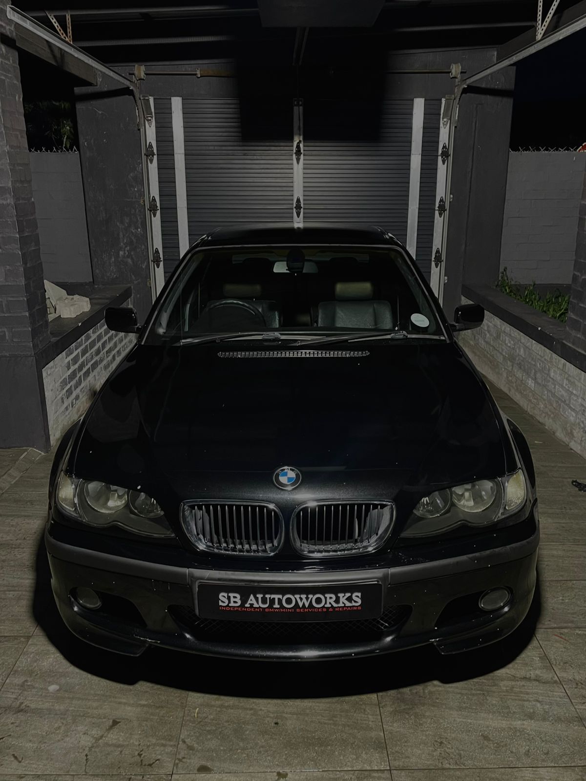 A red performance car in SB AutoWorks garage